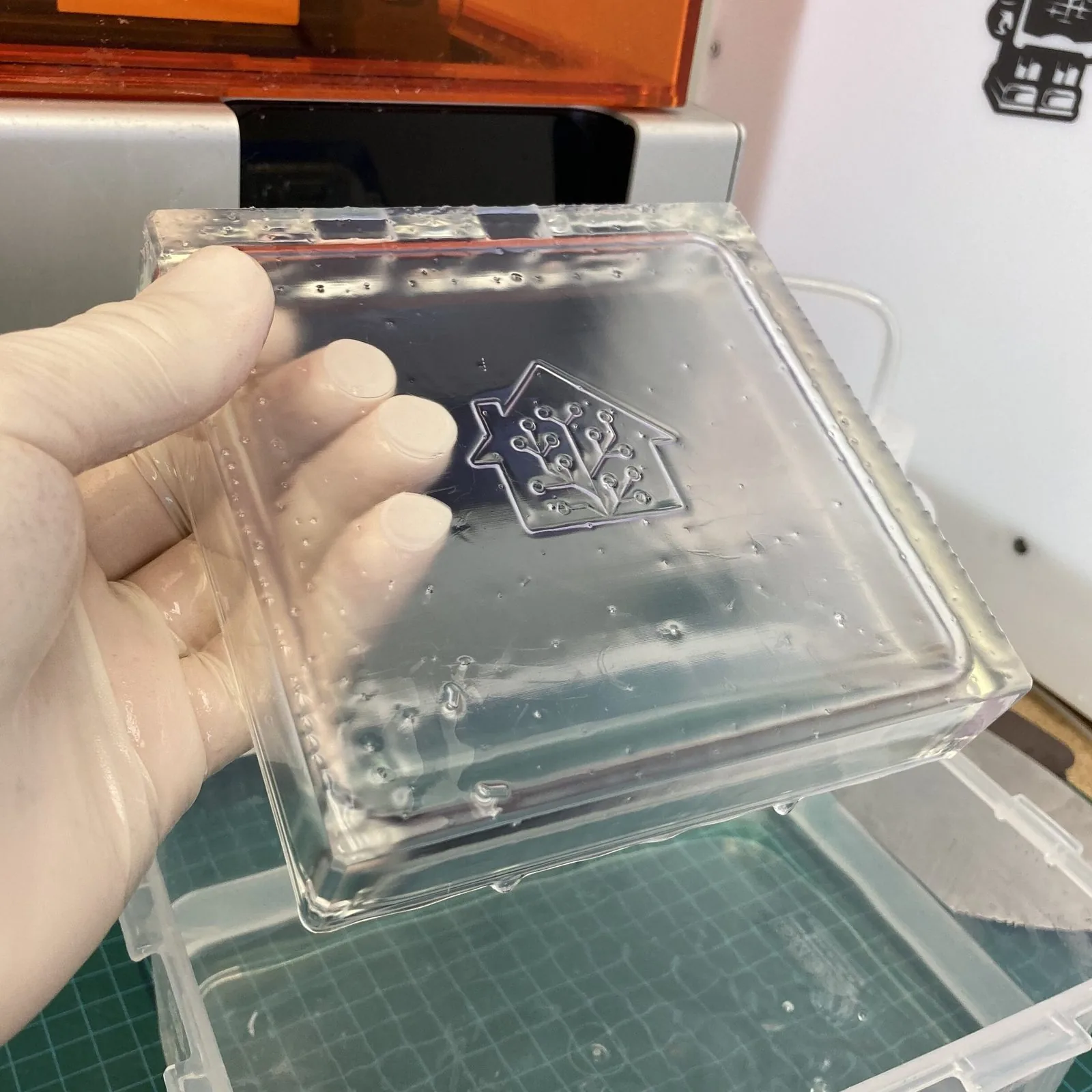 A freshly printed clear prototype cover held up after washing